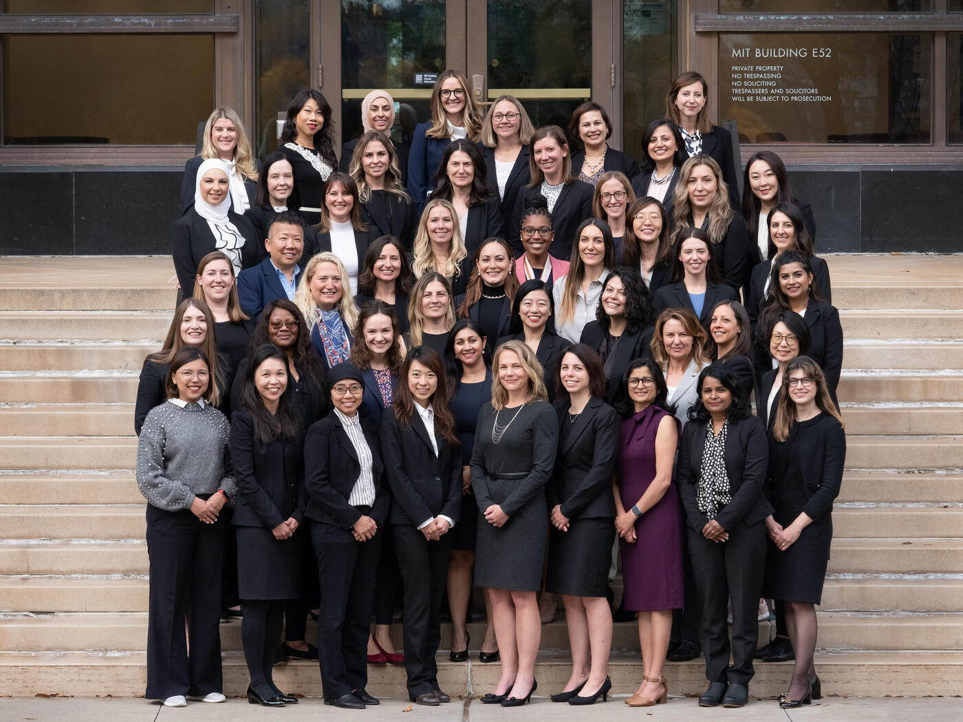 MIT EMBA Class of 2025 women on the steps outside of MIT building E52