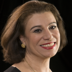 Headshot of a woman smiling into the camera.